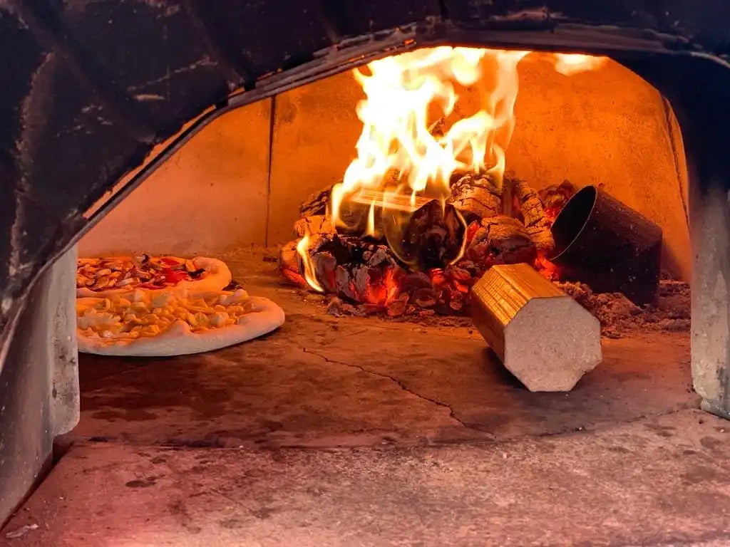 Firewood pizza making process in traditional wood fired oven at Pizzeria On The Road